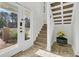 Welcoming foyer featuring a glass front door, staircase with carpet runner, and decorative accents at 941 Law Ln, Mount Pleasant, SC 29464