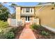 Inviting front yard with landscaped walkway and charming yellow home exterior at 941 Law Ln, Mount Pleasant, SC 29464