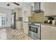 Bright kitchen with stainless steel appliances, tiled backsplash, and creative tile flooring at 941 Law Ln, Mount Pleasant, SC 29464