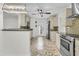 Well-lit kitchen featuring stone countertops, stainless steel appliances, mosaic tile backsplash, and access to back yard at 941 Law Ln, Mount Pleasant, SC 29464