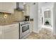 Close-up of the kitchen with stainless steel appliances, granite counters, and tiled backsplash at 941 Law Ln, Mount Pleasant, SC 29464