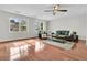 Bright living room with large windows, hardwood floors, a ceiling fan, and stylish furniture at 941 Law Ln, Mount Pleasant, SC 29464