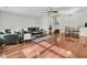 Spacious living room featuring hardwood floors, a ceiling fan, and an open layout to dining area at 941 Law Ln, Mount Pleasant, SC 29464