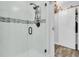 Bathroom shower featuring glass doors, sleek fixtures, and modern tile accents with a sliding barn door nearby at 941 Law Ln, Mount Pleasant, SC 29464