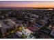 Stunning aerial view of the city, showcasing its charming architecture and picturesque waterfront during a vibrant sunset at 100 Queen St, Charleston, SC 29401