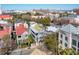 Aerial shot of a charming Charleston home with a balcony surrounded by lush greenery and historic buildings at 100 Queen St, Charleston, SC 29401