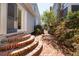 Charming brick walkway leads through the lush backyard garden of this charming home at 100 Queen St, Charleston, SC 29401