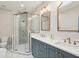 Bright bathroom with double vanity, glass enclosed shower, and elegant fixtures at 100 Queen St, Charleston, SC 29401