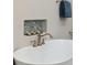 Freestanding tub with bronze faucet fixture and tiled inset for decor at 100 Queen St, Charleston, SC 29401