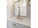 Bathroom features a gray vanity with marble countertop and brass fixtures at 100 Queen St, Charleston, SC 29401