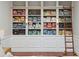Expansive built-in bookcase with brass accents and rolling ladder offering ample storage at 100 Queen St, Charleston, SC 29401
