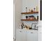 Close-up of decoratively styled built-in shelves and cabinets next to a fireplace at 100 Queen St, Charleston, SC 29401