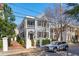 Charming two-story home with double porches, shutters, and a well-manicured front yard at 100 Queen St, Charleston, SC 29401