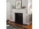 Fireplace with white mantle, dark firebox and hardwood floors at 100 Queen St, Charleston, SC 29401