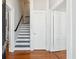 Foyer with staircase, hardwood floors, and neutral paint tones at 100 Queen St, Charleston, SC 29401