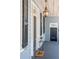 Inviting front porch with stylish light fixture and a charming entrance at 100 Queen St, Charleston, SC 29401