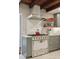 Bright kitchen features a gourmet gas range with custom range hood and marble floors at 100 Queen St, Charleston, SC 29401