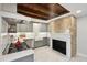 Kitchen features a wood beam ceiling, stainless steel appliances, gas range, and farmhouse sink at 100 Queen St, Charleston, SC 29401