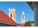 Architectural rooftop view featuring two churches with intricate detailing against a clear blue sky at 100 Queen St, Charleston, SC 29401