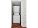 Compact laundry space with a stacked washer and dryer unit for space-saving convenience at 100 Queen St, Charleston, SC 29401