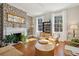 Living room with hardwood floors, fireplace, decorative wallpaper, and wicker furniture at 100 Queen St, Charleston, SC 29401