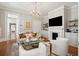 Elegant living room featuring a fireplace, hardwood floors, and designer furnishings at 100 Queen St, Charleston, SC 29401