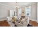 Bright and airy living room with hardwood floors, white furniture, fireplace and elegant touches at 100 Queen St, Charleston, SC 29401