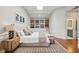 Bright main bedroom with skylight, built-in bookcase, and decorative rug at 100 Queen St, Charleston, SC 29401