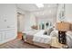 Bright main bedroom with skylight, ceiling fan and access to a private balcony at 100 Queen St, Charleston, SC 29401