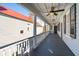 Charming porch with white columns and a ceiling fan providing an inviting outdoor living space at 100 Queen St, Charleston, SC 29401