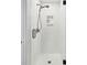 Modern tiled shower with a sleek shower head, handheld sprayer, and built-in niche at 100 Queen St, Charleston, SC 29401