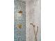 Spa-like shower featuring dual shower heads, mosaic tile accent wall, and marble tile at 100 Queen St, Charleston, SC 29401
