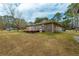 Spacious backyard featuring a well-kept lawn and mature trees at 105 New Ct, Summerville, SC 29483