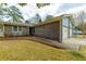 Close-up view of a brick home with blue siding and a well-manicured yard at 105 New Ct, Summerville, SC 29483