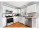 Bright kitchen featuring white cabinets, stainless steel appliances, and hardwood floors at 105 New Ct, Summerville, SC 29483