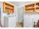 Bright laundry room features updated washer and dryer and convenient above-appliance shelving for storage at 105 New Ct, Summerville, SC 29483