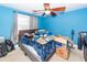 Bedroom with blue walls, ceiling fan, and window with gray curtains at 106 Caveson Dr, Summerville, SC 29483