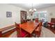 Open dining area with a wooden table, china cabinet, and natural light from the windows at 106 Caveson Dr, Summerville, SC 29483
