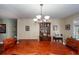 Spacious dining room with a wooden table, chandelier, and decorative display cabinet at 106 Caveson Dr, Summerville, SC 29483