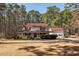 Charming two-story traditional home with a large, inviting wrap-around front porch and mature trees at 106 Caveson Dr, Summerville, SC 29483