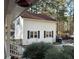 Home exterior with well-maintained siding, shutters, a small yard, and wooded backyard at 106 Caveson Dr, Summerville, SC 29483
