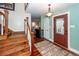 Traditional foyer featuring wood stairs, hardwood floors, a patterned rug, and a stained glass front door at 106 Caveson Dr, Summerville, SC 29483