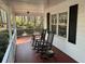 Inviting front porch features a classic design with rocking chairs and views of the wooded front yard at 106 Caveson Dr, Summerville, SC 29483