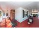 Spacious covered porch with red flooring and white columns, featuring comfortable rocking chairs and swing at 106 Caveson Dr, Summerville, SC 29483