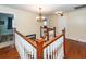 Hallway with wood trim and railings, hardwood floors, and decorative chandelier at 106 Caveson Dr, Summerville, SC 29483
