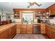 Bright kitchen with stylish wooden cabinets, stainless steel dishwasher, and breakfast bar area at 106 Caveson Dr, Summerville, SC 29483