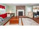 Cozy living room with a brick fireplace, hardwood floors, comfortable seating, and ample natural light at 106 Caveson Dr, Summerville, SC 29483