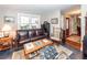 Warm living room with a comfortable leather sofa, natural light, and classic decor at 106 Caveson Dr, Summerville, SC 29483