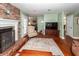 Bright living room with a fireplace, hardwood floors, traditional furniture, and access to other rooms at 106 Caveson Dr, Summerville, SC 29483
