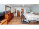 Bright main bedroom with hardwood flooring, large windows, and adjacent hallway access at 106 Caveson Dr, Summerville, SC 29483